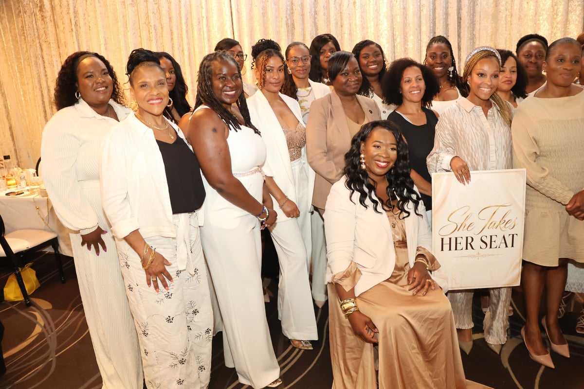 Women gathered for a group portrait at the inaugural She Takes Her Seat event